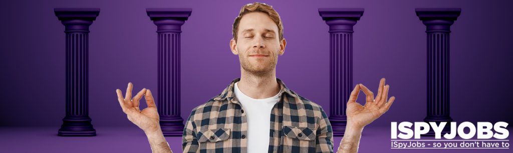 Man standing in front of four pillars and concentrating on his wellbeing. 